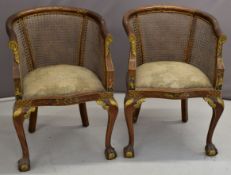 Pair of walnut bergère chairs with Chinoiserie decoration in relief, raised on ball and claw feet,