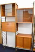 Ladderax mid century modern teak shelving unit comprising three cupboards with sliding doors and a