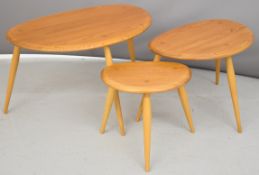 Ercol mid century modern light elm nest of 'pebble' tables, largest diameter 65cm