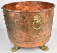 Riveted copper copper with twin brass handles, raised on lion pad feet, H43 x diameter 54cm