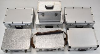 Seven various aluminium flight cases to suit camera outfits or similar, width of largest 48.5cm