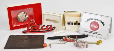 Leica promotional items comprising silver 1979 commemorative medallion in Perspex slab and