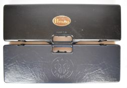 Two shotgun carry cases comprising one Beretta and another with Perazzi label, both with fitted