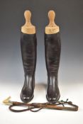Pair of vintage riding boots with trees and a riding whip, approximately size 10