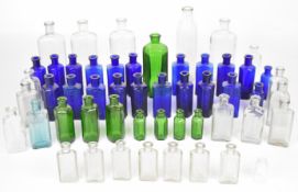 Fifty-two clear and coloured glass medicine and poison bottles of various shapes, some marked 'Not