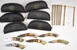 Six Franklin Mint collector's pocket knives featuring pictures of Labrador dogs, in pouches with