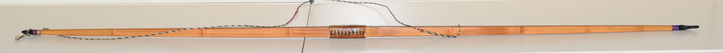 Bamboo laminated wood longbow with mother of pearl inlay and leather grip, 188cm long.