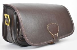 Brown leather shotgun cartridge loader's bag with shoulder strap, unused.