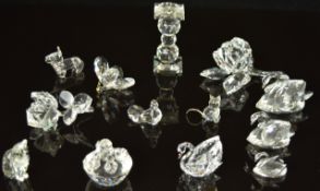 Thirteen Swarovski animals and ornaments including cats, dogs, swans, butterflies etc.