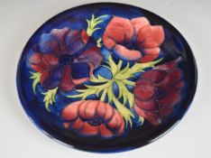 Moorcroft charger decorated in the Anemone pattern, diameter 26cm