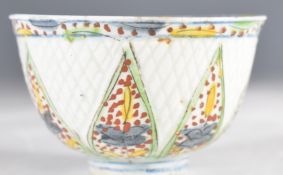 18thC Turkish Kutahya tea bowl with geometric relief moulded and polychrome decoration, height 5cm