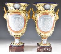 Pair of twin handled pedestal porcelain vases with pate sur pate style decoration, raised on