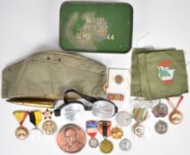 Small collection of badges including Belgium King Albert 1909 - 1934, Spanish Jose Antonio, France