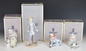 Seven Lladro clown figures with puppies, saxophone etc, all boxed, tallest 23cm