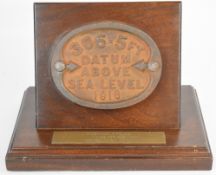 Kynoch Press cast iron datum wall marker '306.5ft Datum Above Sea Level 1916' for building 48