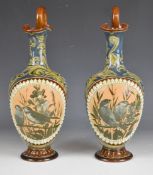 Florence Barlow for Doulton Lambeth pair of art pottery pedestal ewers decorated with birds