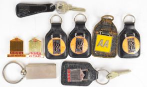 Nine Rolls-Royce and other keyrings and badges, to include enamel examples and Rolls-Royce