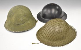 Three British steel helmets, two 'Brodie' style with liners and chin strap, the other a 'Turtle'