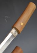Japanese short sword with plain wooden grip, signed tang, crossed leaf / feather motif to habaki,