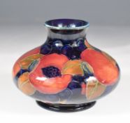 Moorcroft squat pedestal vase decorated in the Pomegranate pattern, signed to base, H8cm