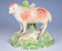 Early Staffordshire figure of a ewe with lamb, the underside of the base concave, H10cm