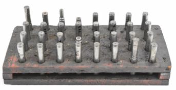 A set of 32 gunsmiths 12 bore hardened steel plugs for shotgun barrel dent raising, in wooden stand.