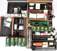 A collection of shotgun and rifle cleaning equipment including seven cleaning kits, pull throughs,