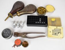 A collection of muzzle loading and other gun equipment including two powder flasks, bullet mould, .