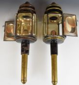 A pair of Victorian brass and black lacquer carriage lantern lamps with bevelled glass windows by
