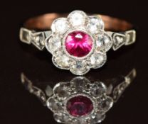 A 9ct gold ring set with a synthetic ruby surrounded by quartz, 1.7g, size K