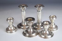 Six hallmarked silver candlesticks including two pairs, larger Birmingham 1907, maker Ellis & Co,