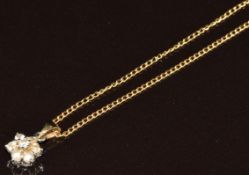 A 14k gold pendant set with diamonds in a cluster (0.7g) on 18k gold chain (1.8g)