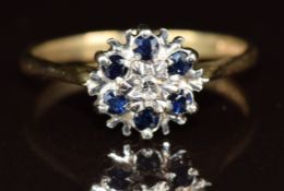 A 9ct gold ring set with diamonds and sapphires in a cluster, 2g, size M/N