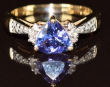 A 9k gold ring set with a trilliant cut tanzanite of approximately 1.1ct with further diamonds to