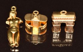 Three 18k gold charms including nude lady and Arc De Triomphe, 4.3g