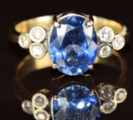 A 14k gold ring set with an oval cut tanzanite of approximately 2.5ct and six diamonds, 5.1g, size
