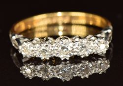 An 18ct gold ring set with five diamonds in a platinum setting, 2.5g, size L