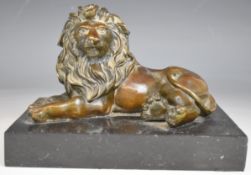 Bronze figure of a recumbent lion on marble base, L17 x H14cm