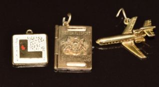 Three 9ct gold charms including mini passport, plane and 'L', 8.8g