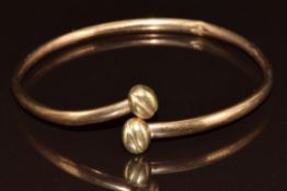 A 9ct gold bangle with coffee bean ends, 5.2g
