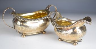 Georgian hallmarked silver milk jug and matching sugar bowl both raised on four ball feet, milk