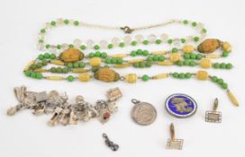 A silver charm bracelet with 20 charms including 'I love you' signet ring, Nuno bible, toadstool