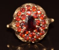 A 9ct gold ring set with a cluster of garnets, 4.6g, size N