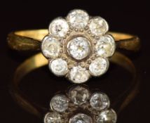 An 18ct gold ring set with old cut diamonds in a cluster, 3.2g, size T