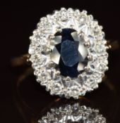A 9ct gold ring set with an oval cut sapphire of approximately 1.2ct surrounded by diamonds, 4.3g,