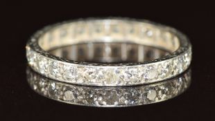 A platinum eternity ring set with 24 round cut diamonds, 2.2g, size L