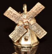 A 9ct gold charm in the form of a windmill with turning action, 2.5g