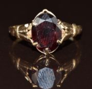 A 9ct gold ring set with an oval cut garnet, 1.6g, size K