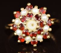 A 9ct gold ring set with garnets and pearls in a cluster, 3.5g, size L