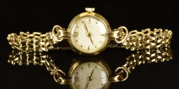 Unnamed 9ct gold ladies wristwatch with gold hands and hour markers, silver dial and unsigned